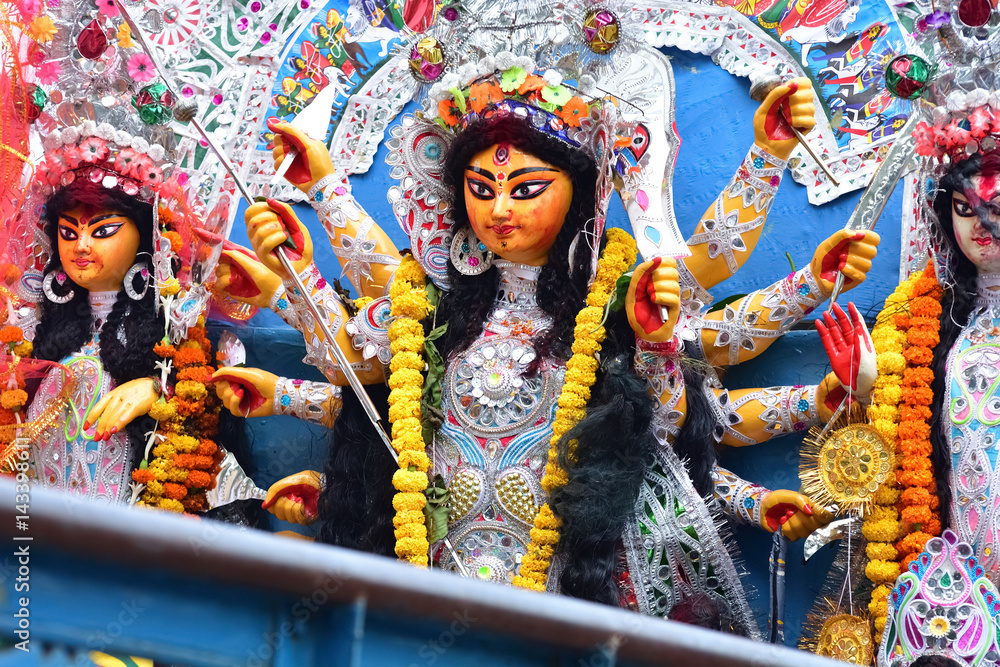 Fototapeta premium Immerse goddess Durga idol in ganges river during Durga Puja festival in Kolkata, India. Durga puja is the biggest festival in West Bengal.