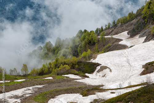 Slope of the mountain with snow and clouds