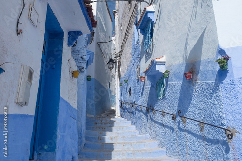 Alley with Flowerpots and Stairs in the Medina of Chefchaouen © DorSteffen