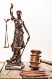 Statue of lady justice and mallet on wooden table, Law concept