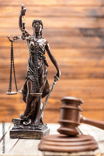 Statue of lady justice and mallet on wooden table  Law concept