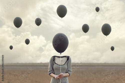 surreal image of woman and blacks balloons flying photo