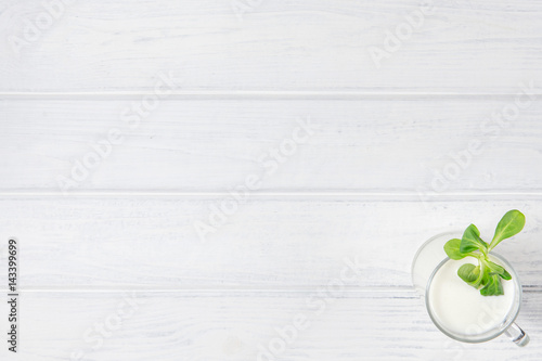 A Cup of yogurt on a white table. Copyspace for text.