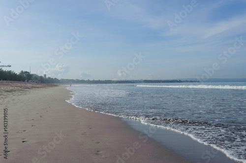  Calm ocean with small waves. Tropical landscape with a view of the volcanoes. 