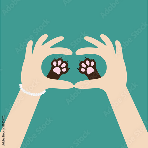 Two womans hands holding cute cat dog paw print. Love and care pet animals. Helping hand concept. Adopt, donate. Flat design. Green background. Template.
