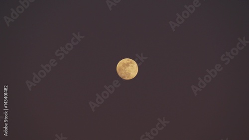 Full moon on a cloudy night sky photo
