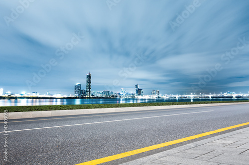 empty road with cityscape and skyline