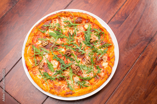 Tasty arugula nuts and blue cheese pizza