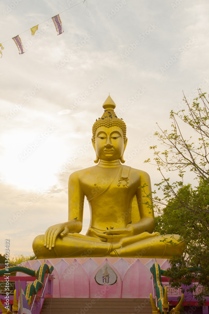 Big Golden Buddha statue over scenic white and blue sky at Wat Sai Dong Yang Temple. Phichit, Thailand. Big Golden Buddha statue over scenic white and blue sky at Wat Sai Dong Yang Temple. Phichit, Thailand.