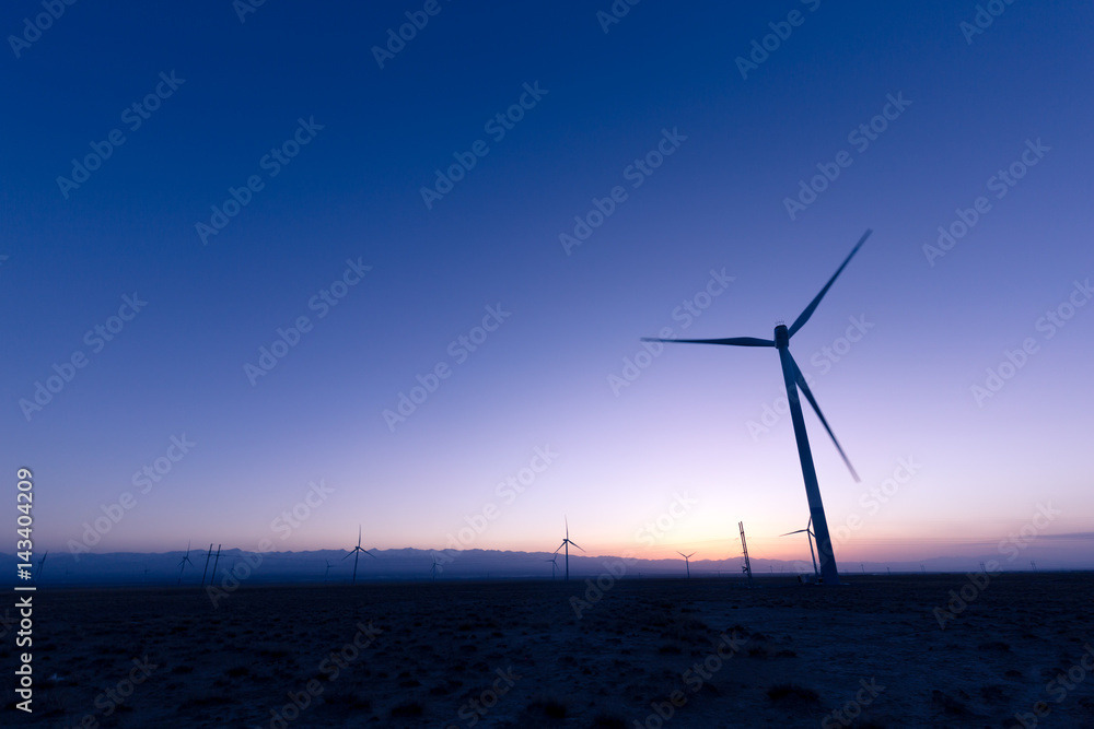 wind turbines in field at twilight
