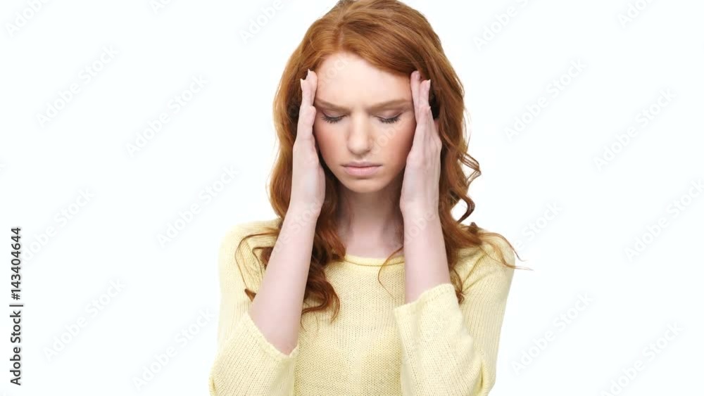 Stressed tired woman with headache holding her hands on head isolated over background Stressed tired woman with headache holding her hands on head isolated over background