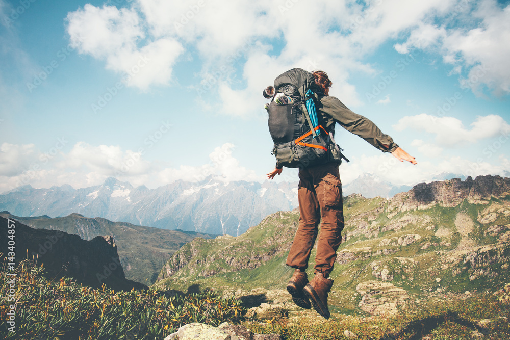 Happy Man jumping levitation with heavy backpack at mountains Lifestyle Travel emotional euphoria success concept adventure active vacations outdoor .