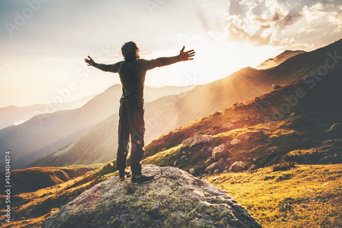 Valokuva Happy Man raised hands at sunset mountains Travel Lifestyle emotional concept ad