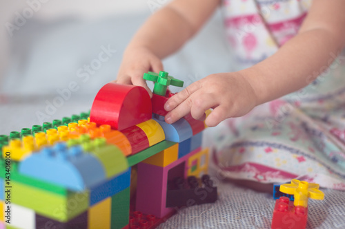 baby builds house from designer, close-up, real