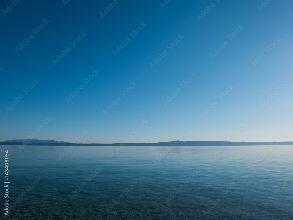 Calm sea and island in background