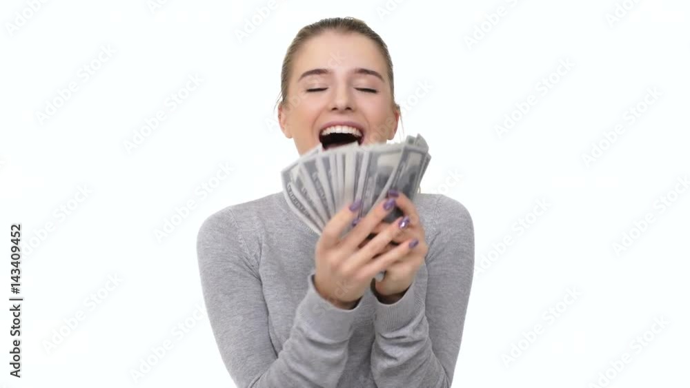 Happy excited young woman counting money bills isolated over white background Happy excited young woman counting money bills isolated over white background