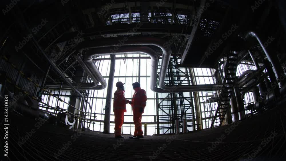 Distorted view of engineer going about his work in industrial plant Distorted view of engineer going about his work in industrial plant