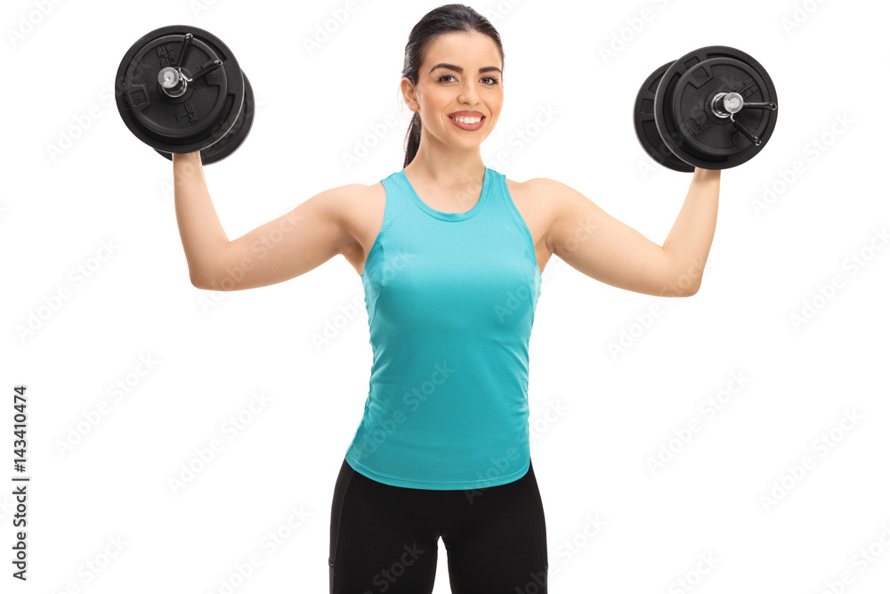 Obraz premium Young woman exercising with dumbbells