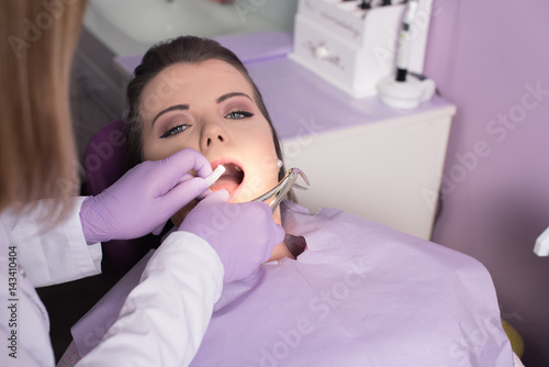 dentist removing teeth and frighten patient 