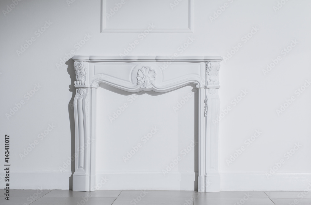 White fireplace in the white interior White fireplace in the white interior