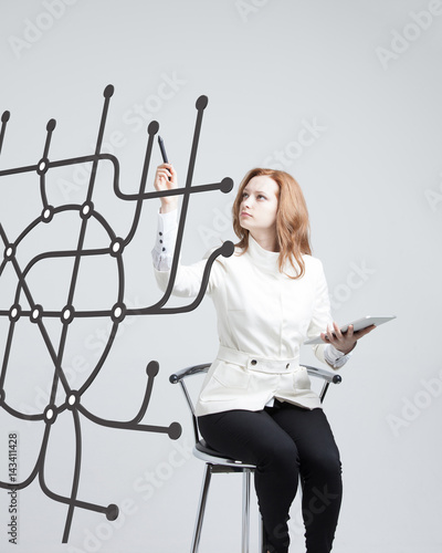 Woman specialist and urban planner working with the interactive subway map. photo