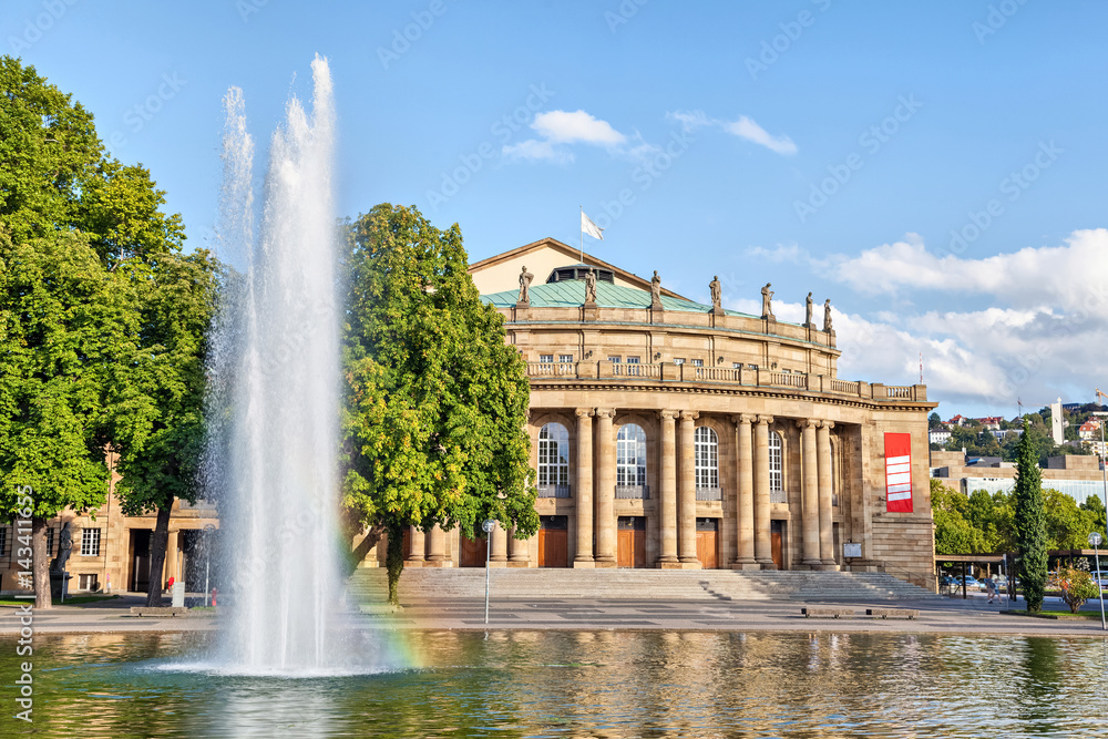 Stuttgart State Theatre building and fountain in Eckensee lake, Germany
