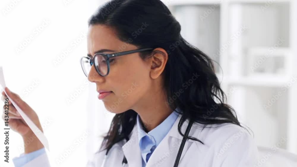 female doctor with laptop and papers at hospital female doctor with laptop and papers at hospital