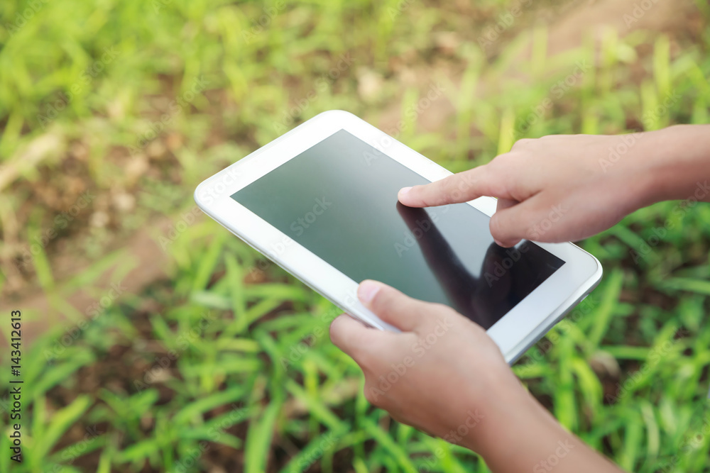 Asian student holding her tablet. Asian student holding her tablet.
