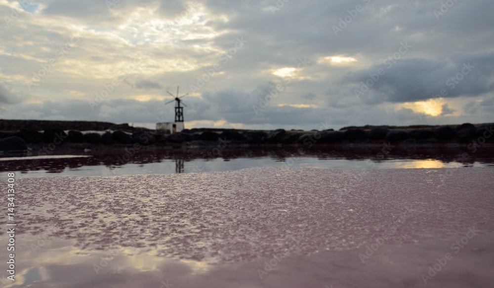 Layers of salt, salines at dawn and old mill 