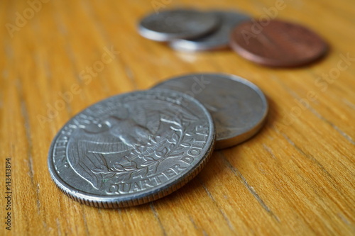 Set of silver Quarter Dollar coins (currency in the USA, American Dollar, USD) on the wooden background