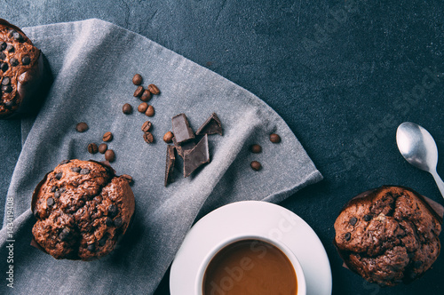 Chocolate muffins and coffee on a dark background