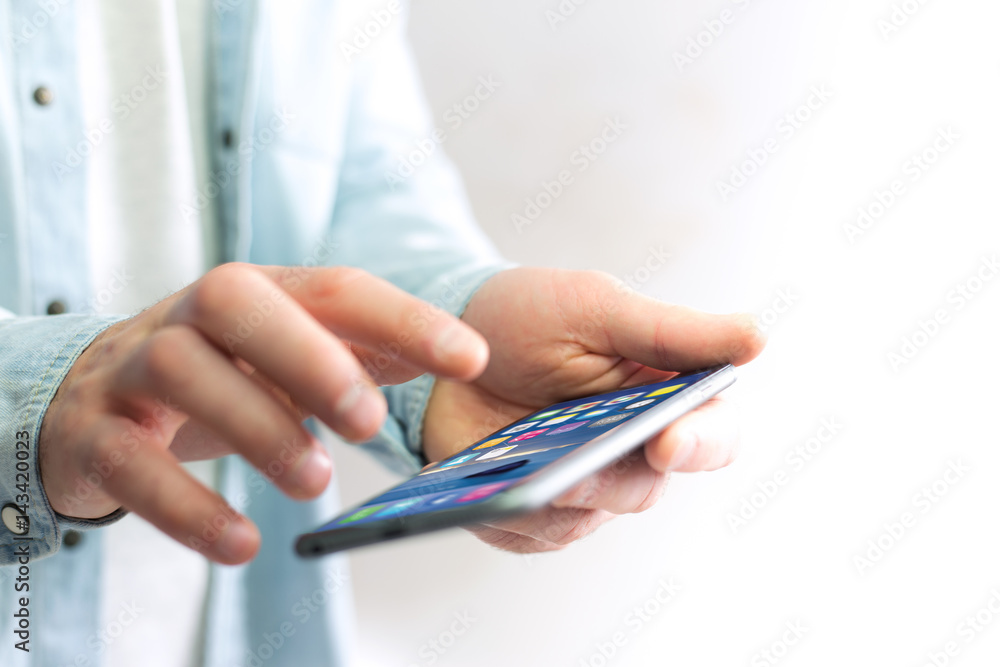 Hand holding black smartphone with operating system screen Hand holding black smartphone with operating system screen