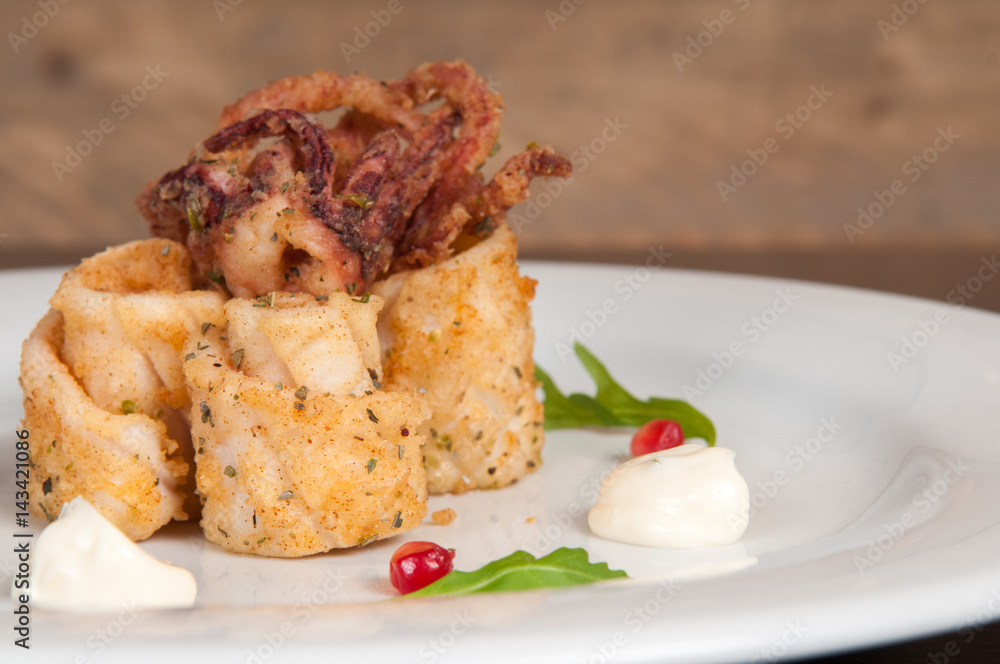 Calamari freshly prepared seafood on a white plate Calamari freshly prepared seafood on a white plate