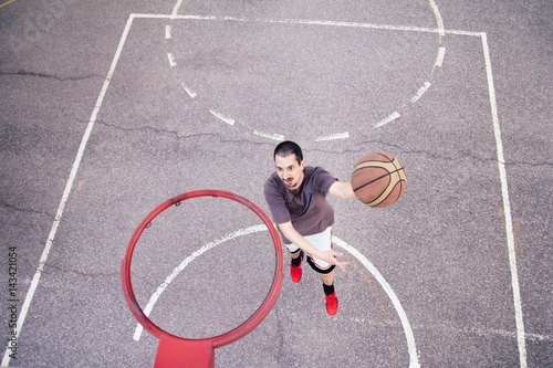 Basketball player outdoor practicing. Street ball. © disq