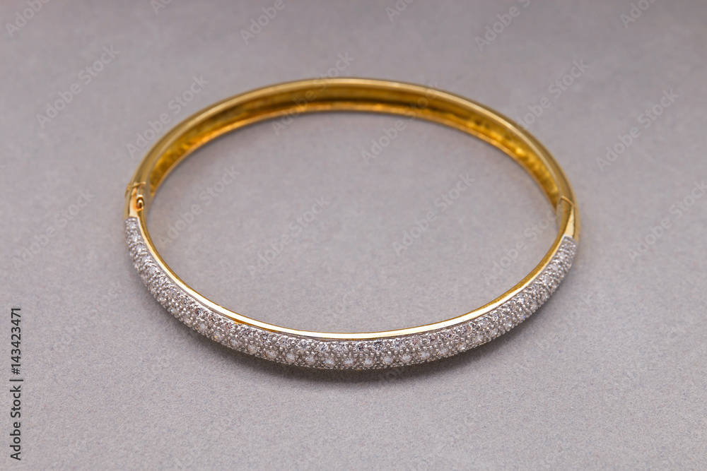 Gold Diamond Bracelet on Gray Background Gold Diamond Bracelet on Gray Background