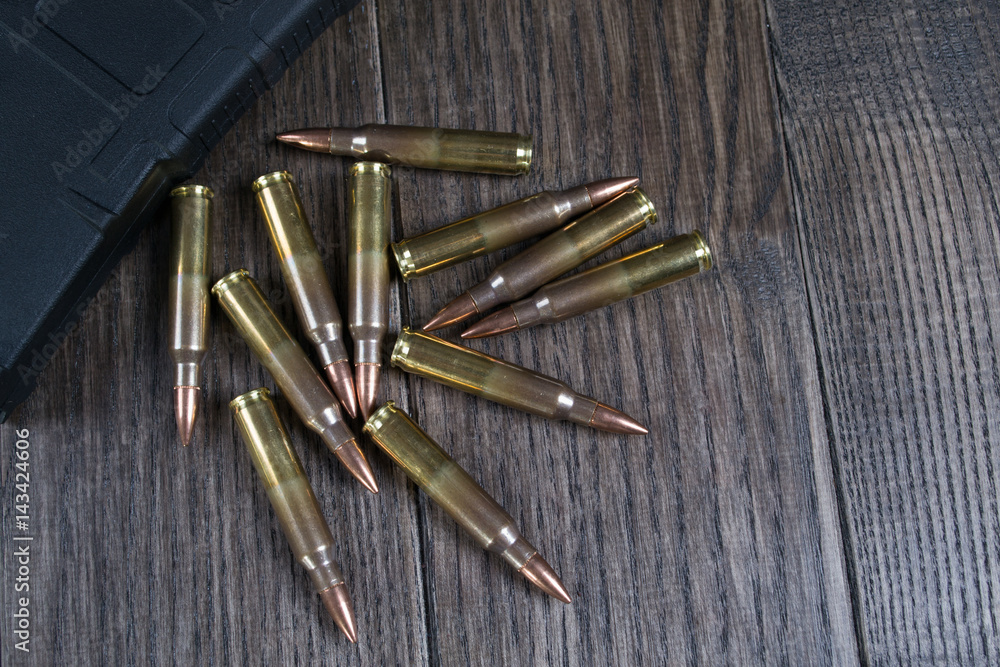 Group of ammunition on a dark wooden background. Group of ammunition on a dark wooden background.
