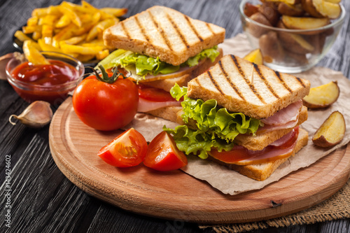 club sandwich with Tomato  lettuce  bacon  ham and french fries