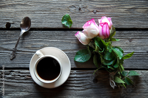 cup of coffee with red rose and and copy space on wood background. breakfast on Mothers day, Women's day, valentine's day or birth day. hot drink, flowers