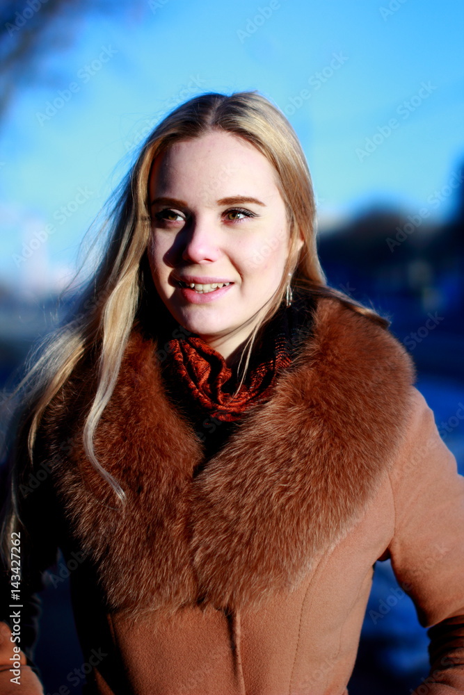 Winter portrait. Young, beautiful woman in winter dress looking in camera. Winter portrait. Young, beautiful woman in winter dress looking in camera.