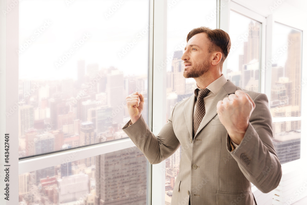 Successful businessman expressing confidence in the office Successful businessman expressing confidence in the office