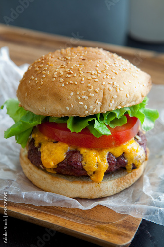 Cheeseburger stacked high with lettuce and tomato