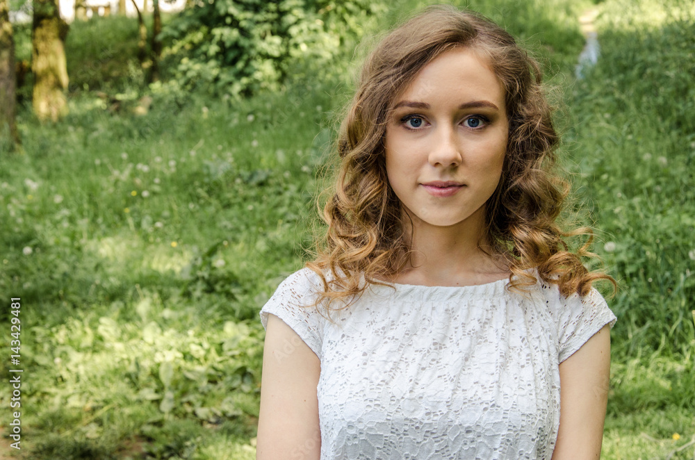 Portrait of a beautiful stylish woman on the background of the city and the green nature Portrait of a beautiful stylish woman on the background of the city and the green nature