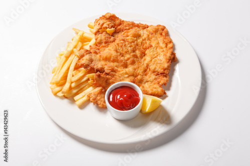 Fried fish and chips on the white plate photo