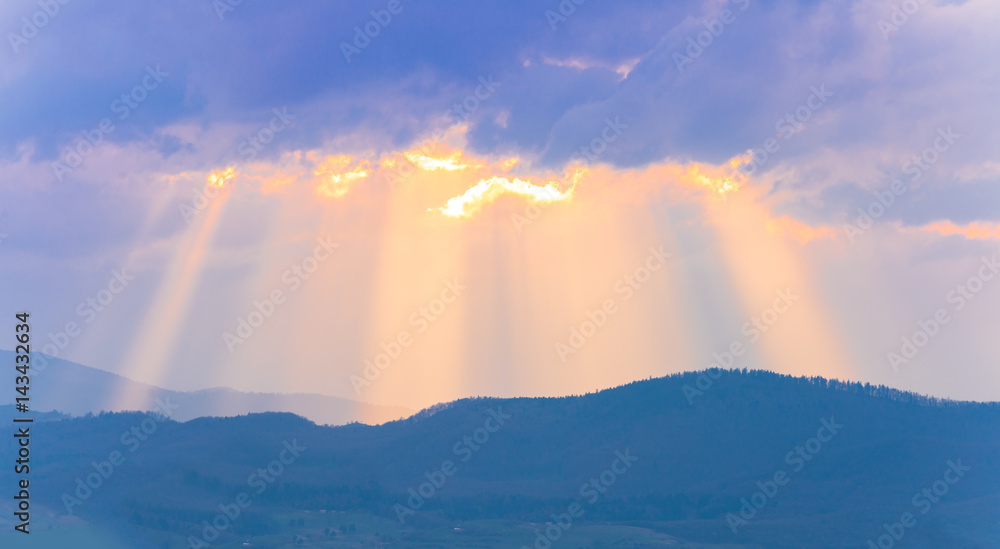 Beautiful colorful sunset background with sun rays over the sky