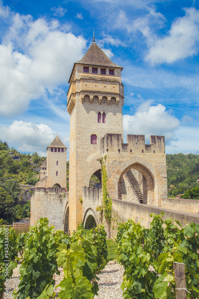 Summer view of medieval stone Valentre Bridge with vineyard in Cahors, France