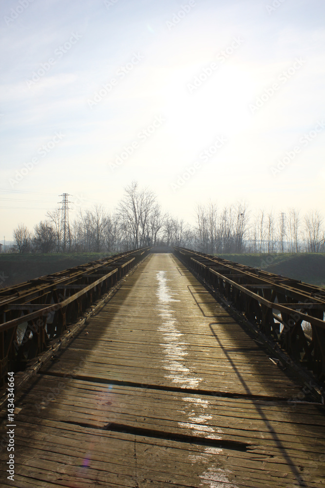 Old steel and wooden bridge in the middle of the countryside