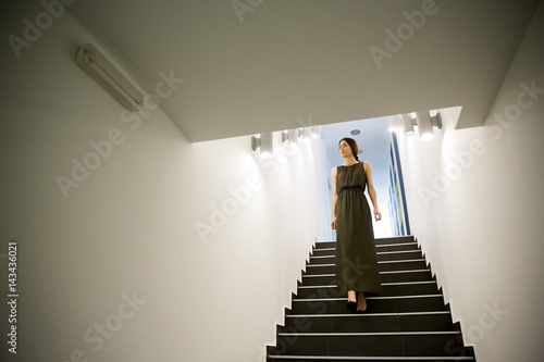 Woman coming down the stairs in the office