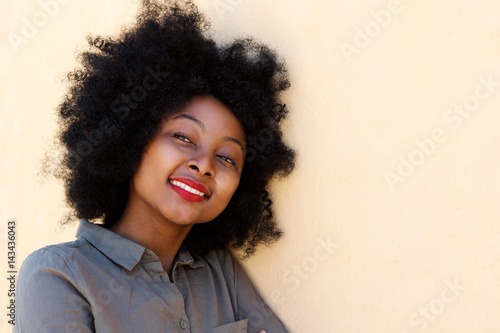 Close up young african woman smiling and thinking © mimagephotos