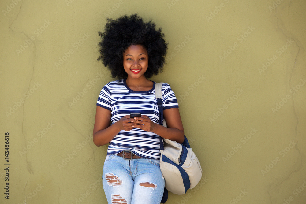 Fototapeta premium happy beautiful woman with smart phone and bag