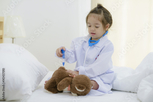 little girl kid imagination works doctor in future by injection a toy practice